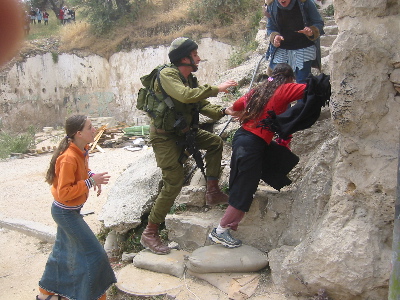 Settler girls stopped by Israeli soldier from attacking Palestinian girls going home from school